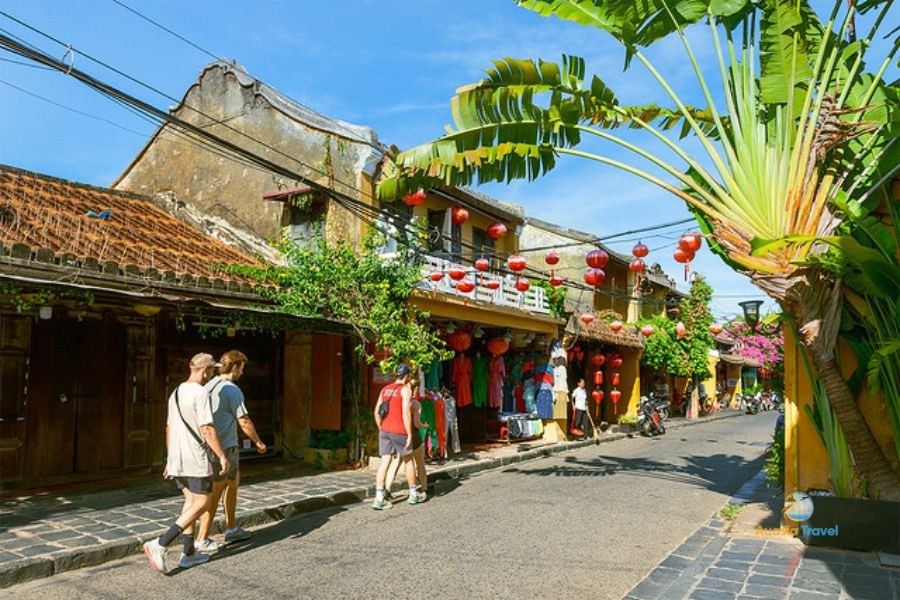 Tourists walking in Hoi An ancient town shown on Vietnam travel guide map.