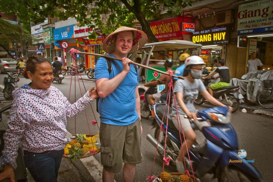 Traveler experiences daily life with local people on Vietnam travel guide map