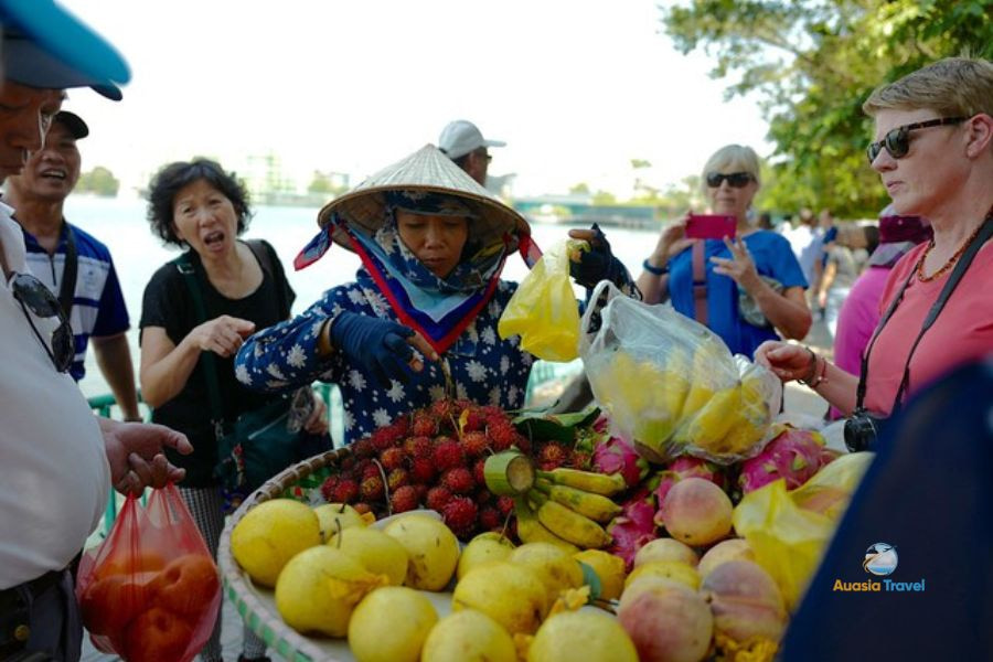 Vendor sells fruits in Vietnam street market